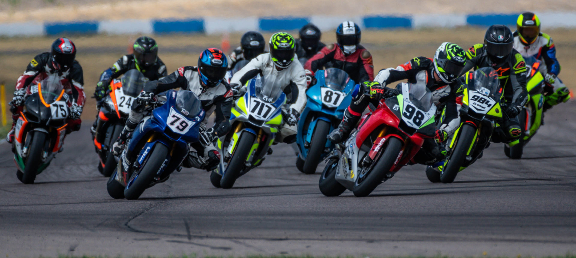 James Wilkerson (98), Mike Applegate (79), Ray Thornton (717), Phillip Hergenrader (87), Nick Dremel (984), and Casey Smith (75) charge into Turn One at the start of the MRA Race of the Rockies race at High Plains Raceway. Photo by Kelly Vernell, courtesy MRA.