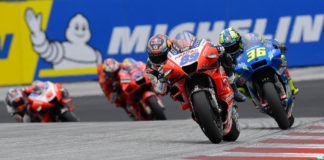 Jorge Martin (89) leads Joan Mir (36), Jack Miller (43), and Johann Zarco (5) in front of a big Michelin sign. Photo courtesy Dorna.
