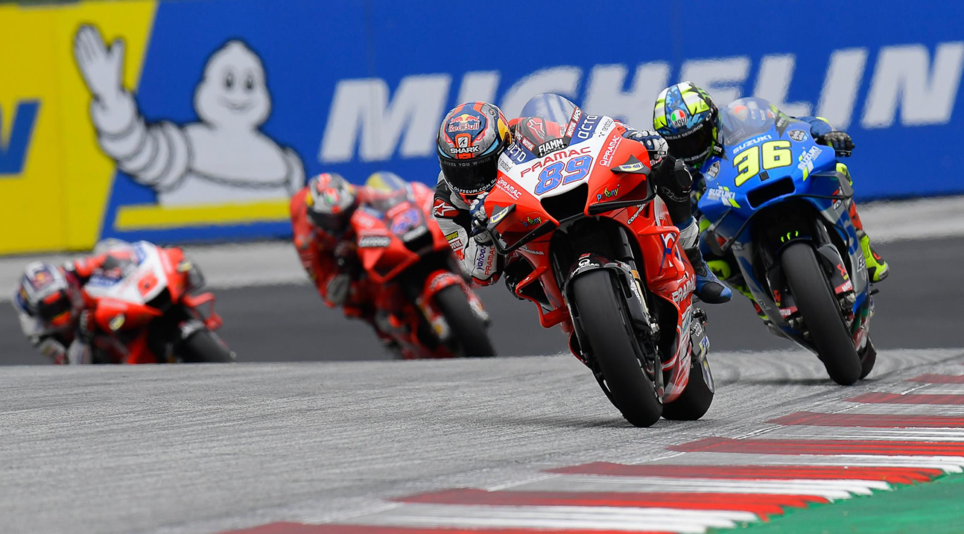 Jorge Martin (89) leads Joan Mir (36), Jack Miller (43), and Johann Zarco (5) in front of a big Michelin sign. Photo courtesy Dorna.