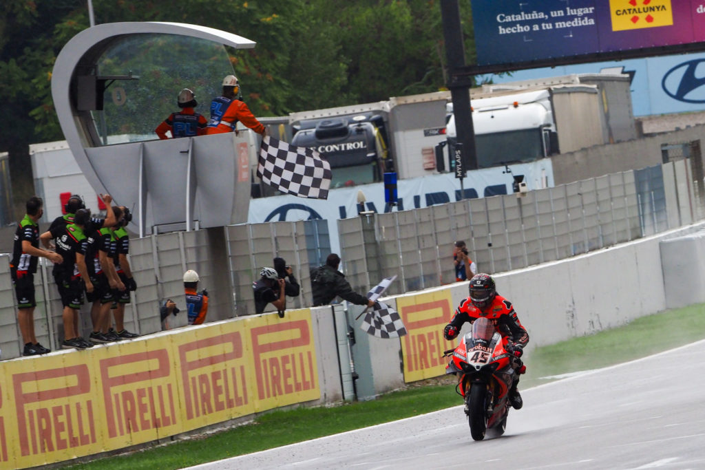 Scott Redding takes the checkered flag first in Race One at Catalunya. Photo courtesy Dorna.