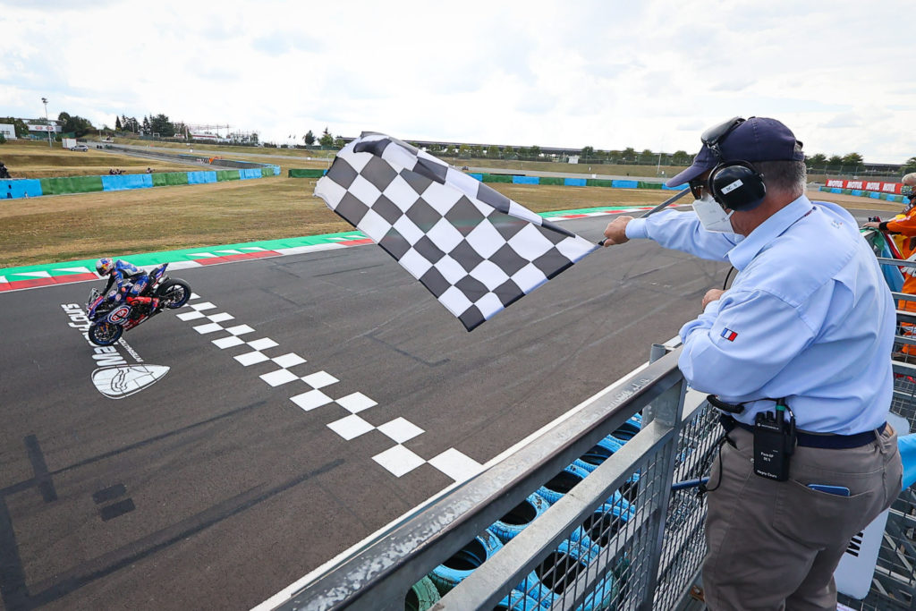 Toprak Razgatlioglu (54) celebrates his Race One victory with a rolling stoppie across the finish line. Photo courtesy Dorna.