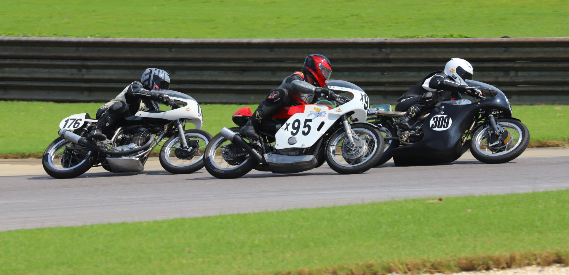 Tim Joyce (309), Andrew Mauk (x95), and Wes Orloff (176) battle during an AHRMA Vintage Cup race at Barber Motorsports Park. Photo by etechphoto.com, courtesy AHRMA.