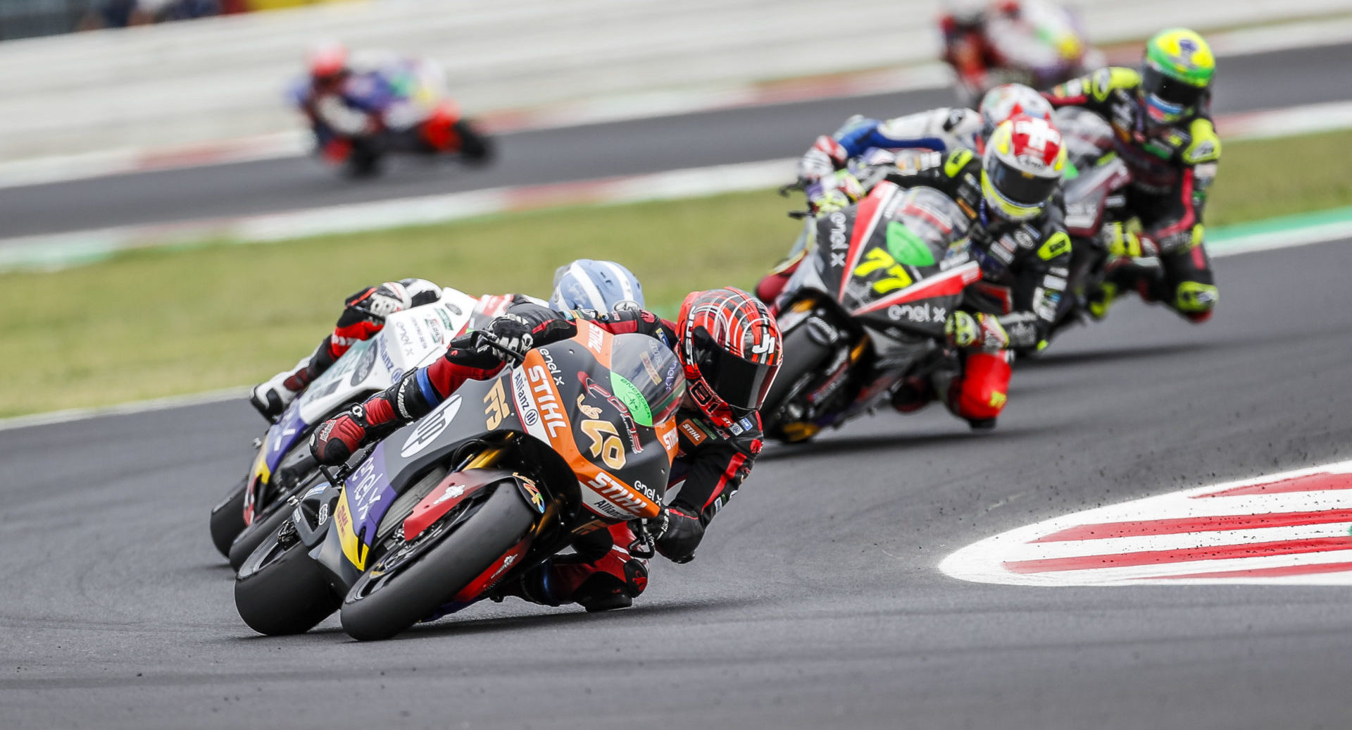 Jordi Torres (40) leads a group of riders during a MotoE World Cup race in 2021. Photo by Jesus Robledo, courtesy Energica.