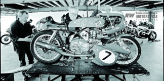 Dave Roper (center) and Gordon Pulis work on Roper’s Harley-Davidson/Aermacchi CRTT 250 Sprint racebike, in the garages. Photo by John Owens.