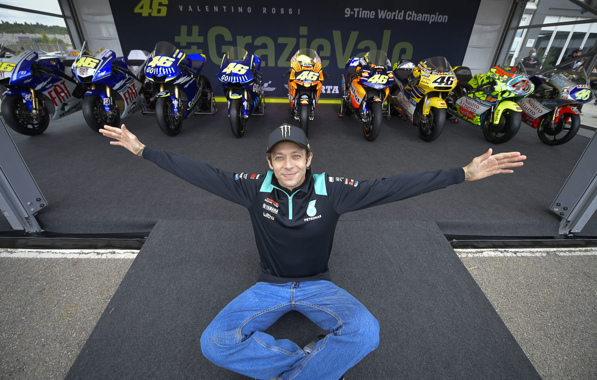 Valentino Rossi reunites with all of his World Championship-winning racebikes, which are arranged in chronological order from right to left. Photo courtesy Dorna.