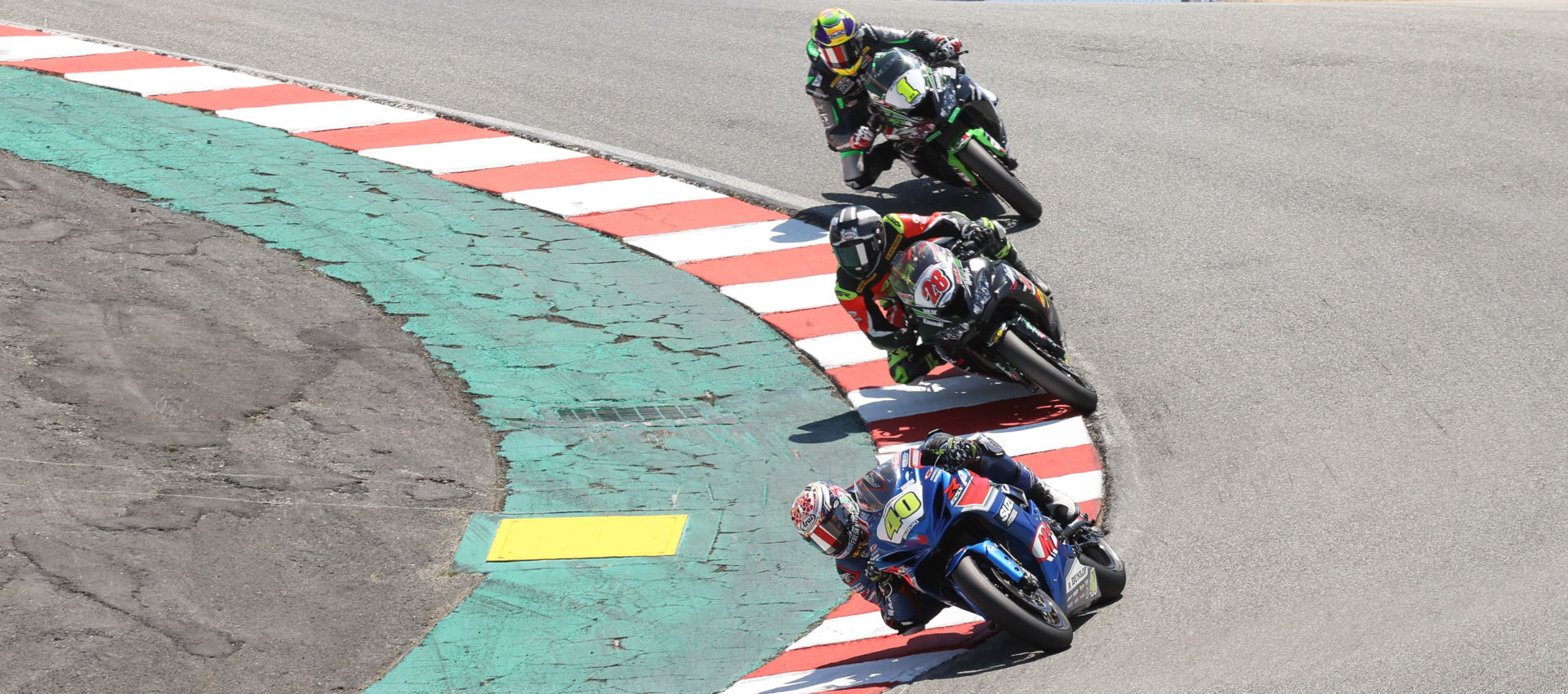Cory Ventura (28) battling with Sean Dylan Kelly (40) and Richie Escalante (1) for the lead during MotoAmerica Supersport Race Two at Laguna Seca in 2021. Photo by Brian J. Nelson.