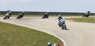 CJ Lukacs (77) leads Trisha Dahl (44) and the rest of the Royal Enfield Build. Train. Race. field at PittRace. Photo by Brian J. Nelson.