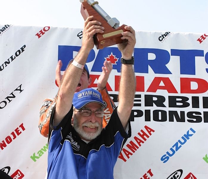 Tuner Paul Fournier hoists the 'Big Bolt' Team of the Year trophy above his head in September 2004 after leading the Picotte Performance squad to two championships that season. Photo by Rob O'Brien, courtesy CSBK.