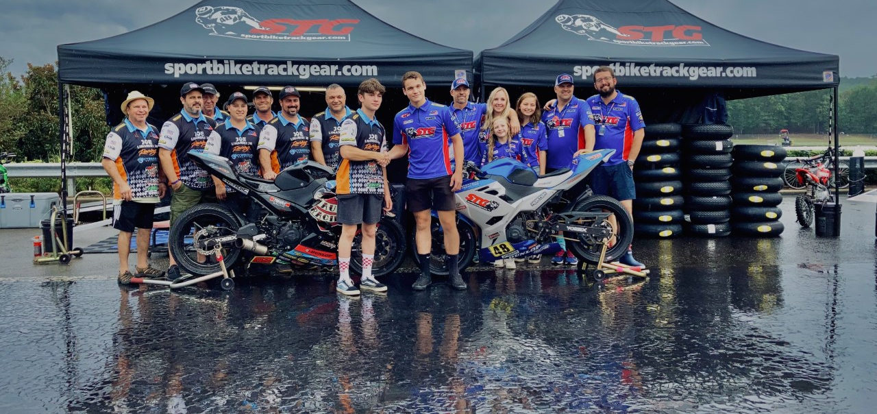 Max Van (foreground right) and Joseph LiMandri, Jr. (foreground left) with their teams. Photo courtesy SportbikeTrackGear.com.