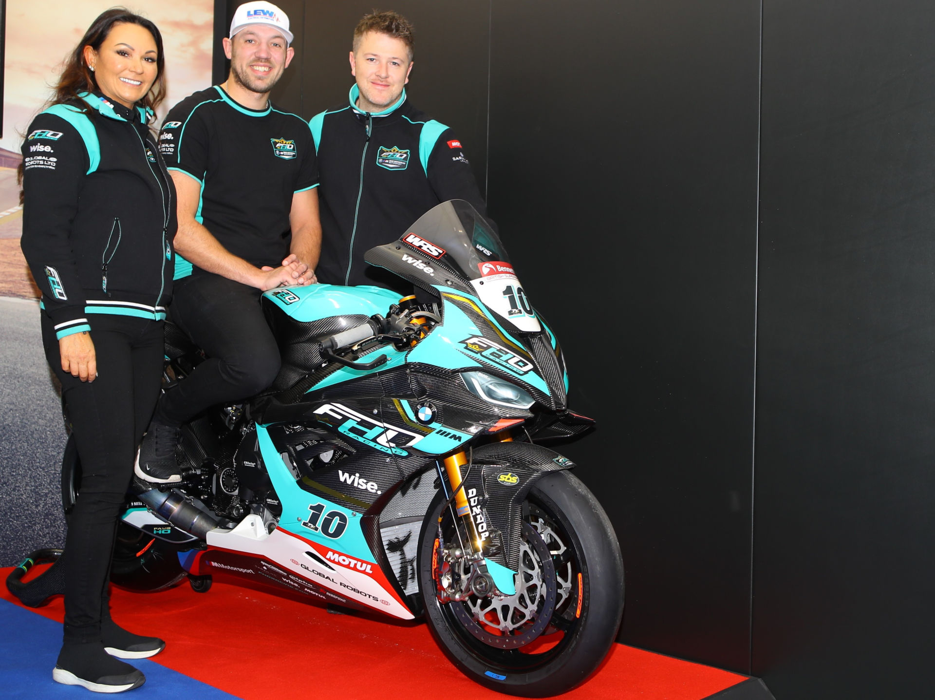 FHO Racing BMW owner Faye Ho (left) with Peter Hickman (center) and Brian McCormack (right). Photo courtesy FHO Racing.