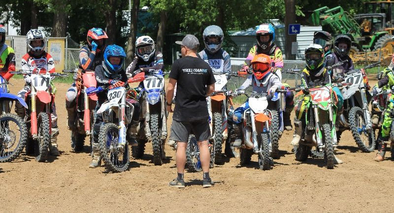 A motorcycle riding coach with students. Photo courtesy USMCA.