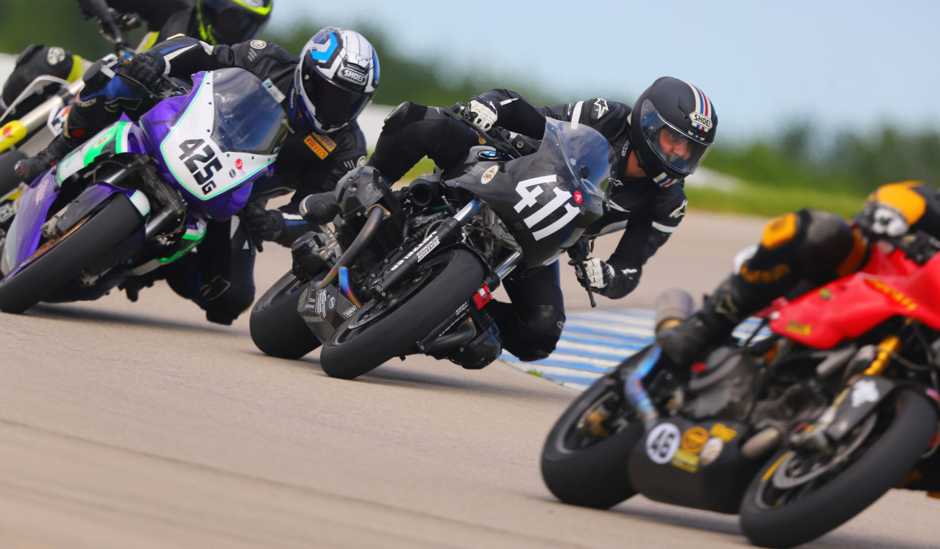 AHRMA racers Gabriel Figueroa (425G) and James-Derek Mayo (411) in action at Heartland Motorsports Park in 2021. Photo by etechphoto.com, courtesy AHRMA.