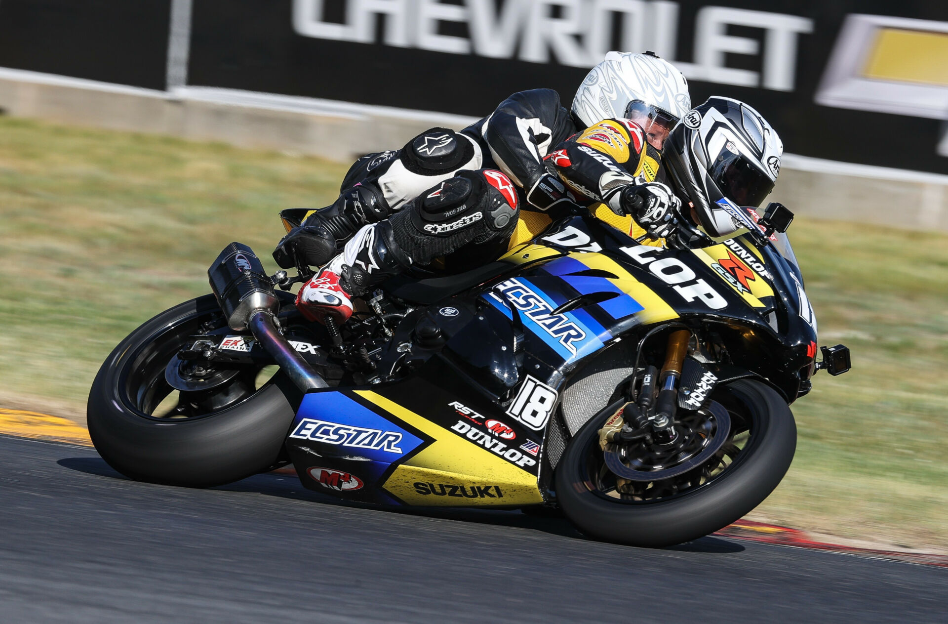 Chris Ulrich giving a fan a ride on the Dunlop ECSTAR Suzuki GSX-R1000 two-seat Superbike during a MotoAmerica event in 2021. Photo by Brian J. Nelson.