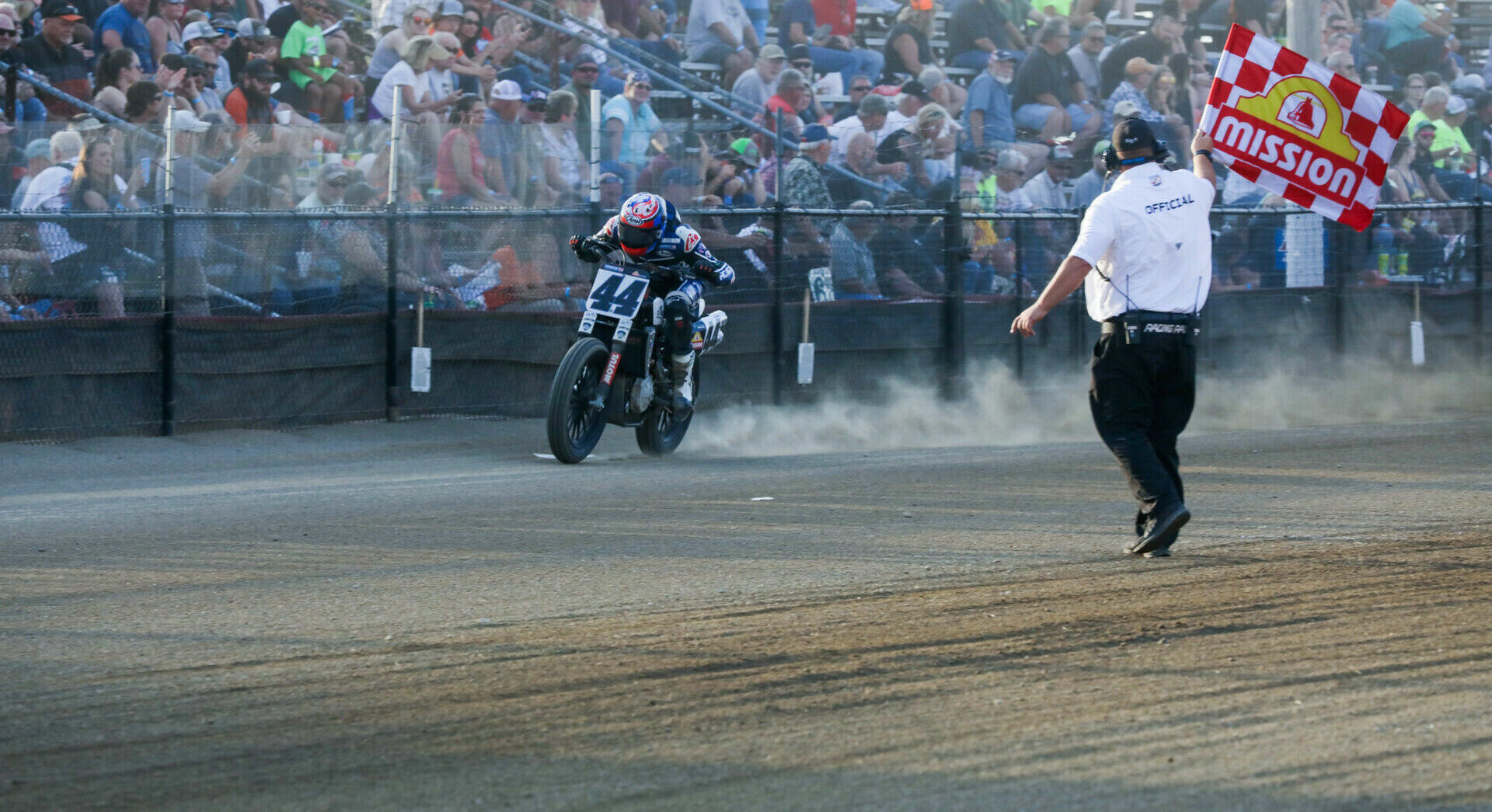 Brandon Robinson (44) takes a Mission-branded checkered flag at an AFT event in 2021. Photo courtesy AFT.