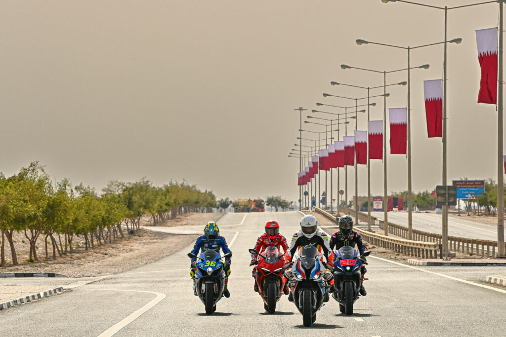 Cafu, riding a BMW M1000RR, leads Fabio Quartararo (20), Francesco Bagnaia (63), and Joan Mir (36) on a ride to Lusail Iconic Stadium. Photo courtesy Dorna.