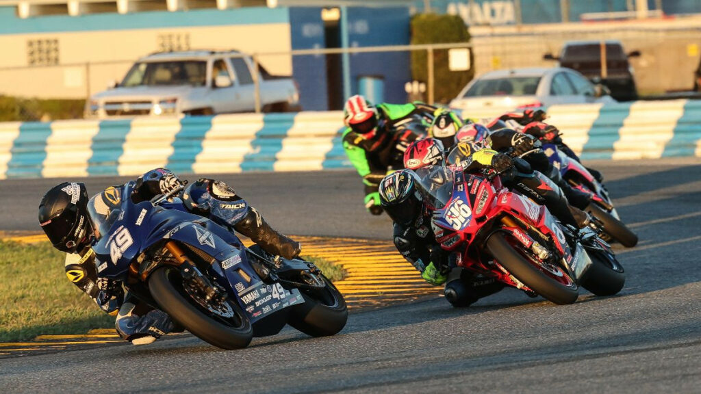 Hayden Schultz (49) leads Anthony Mazziotto (516) and the rest of the Twins Cup pack en route to his first-career MotoAmerica victory. Photo by Brian J. Nelson, courtesy MotoAmerica.
