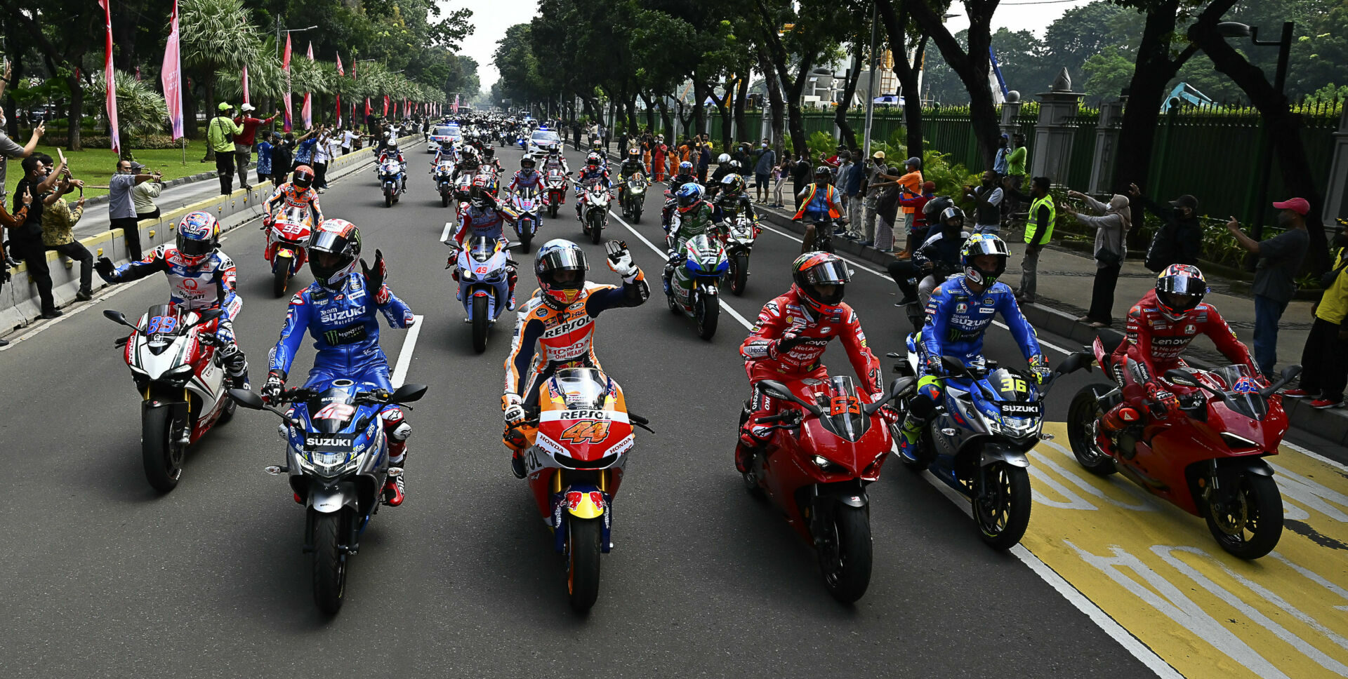 MotoGP riders, including (front row from left) Jorge Martin, Alex Rins, Pol Espargaro, Francesco Bagnaia, Joan Mir, and Jack Miller along with Indonesian President Joko Widodo (at the back of the first group wearing a white facemask), lead a parade through the streets of the Indonesian capital city of Jakarta. Photo courtesy Dorna.