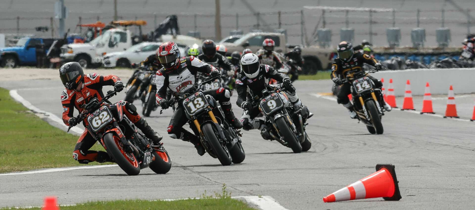 The start of RSD Super Hooligan Race One at Daytona with Andy DiBrino (62) leading Cory West (13), Nate Kern (9), Frankie Garcia (14), and the rest of the field through the infield. Photo by Brian J. Nelson.