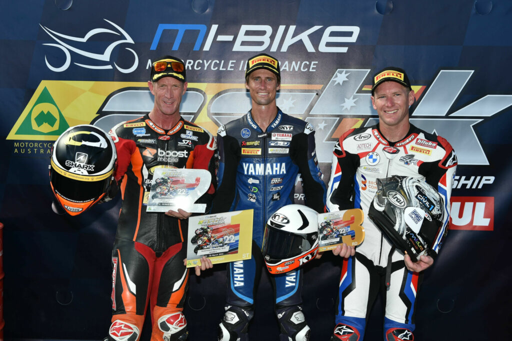 Mike Jones (center), Wayne Maxwell (left) and Josh Waters (right) on the podium at Queensland Raceway. Photo by Karl Phillipson/@optikalphoto, courtesy ASBK.
