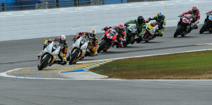 Brandon Paasch (96) leads teammate Danny Eslick (69), Richie Escalante (behind Eslick), Josh Herrin (2), Max Angles (64), Cameron Petersen (450, Geoff May (99), and Sam Lochoff (44) early in the 80th Daytona 200. Photo courtesy Triumph.