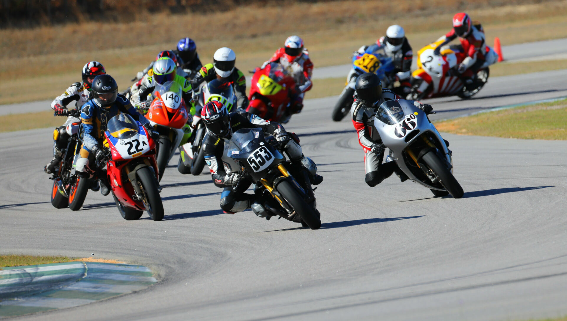 Paul Canale (553) leads John Beldock (66o), Mark Tenn (22a) and the rest of the AHRMA Sound of Thunder field at Carolina Motorsports Park. Photo by Etechphoto.com, courtesy AHRMA.