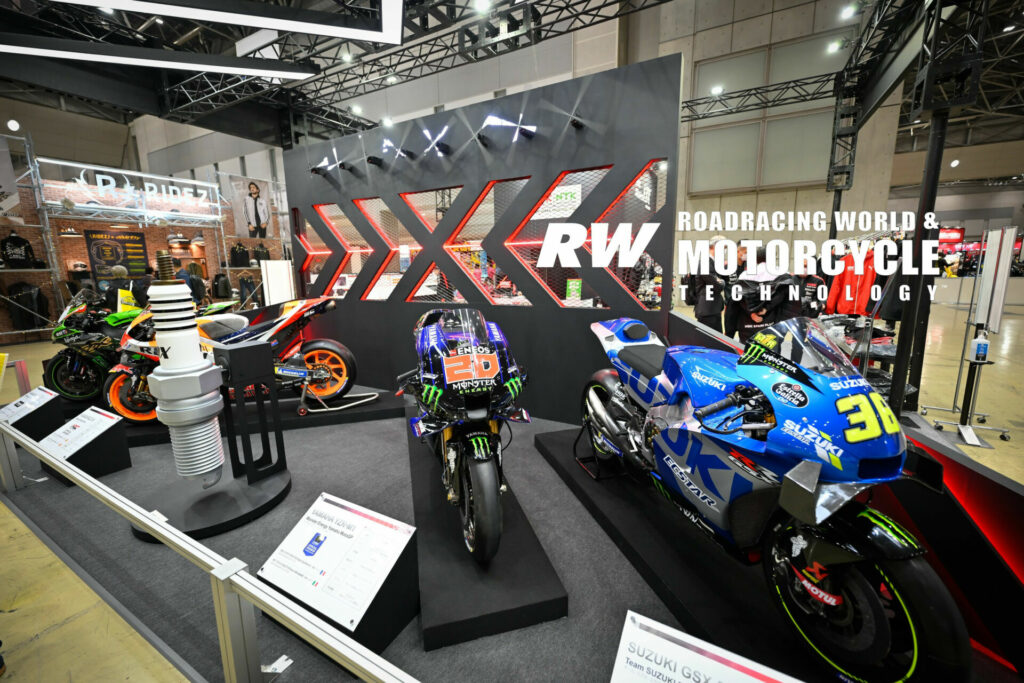 There were several sponsored racebikes on display in NGK Spark Plug's area, including bikes identified as belonging to Mark Marquez (93), Fabio Quartararo (20), and Joan Mir (36). Photo by Kohei Hirota. 