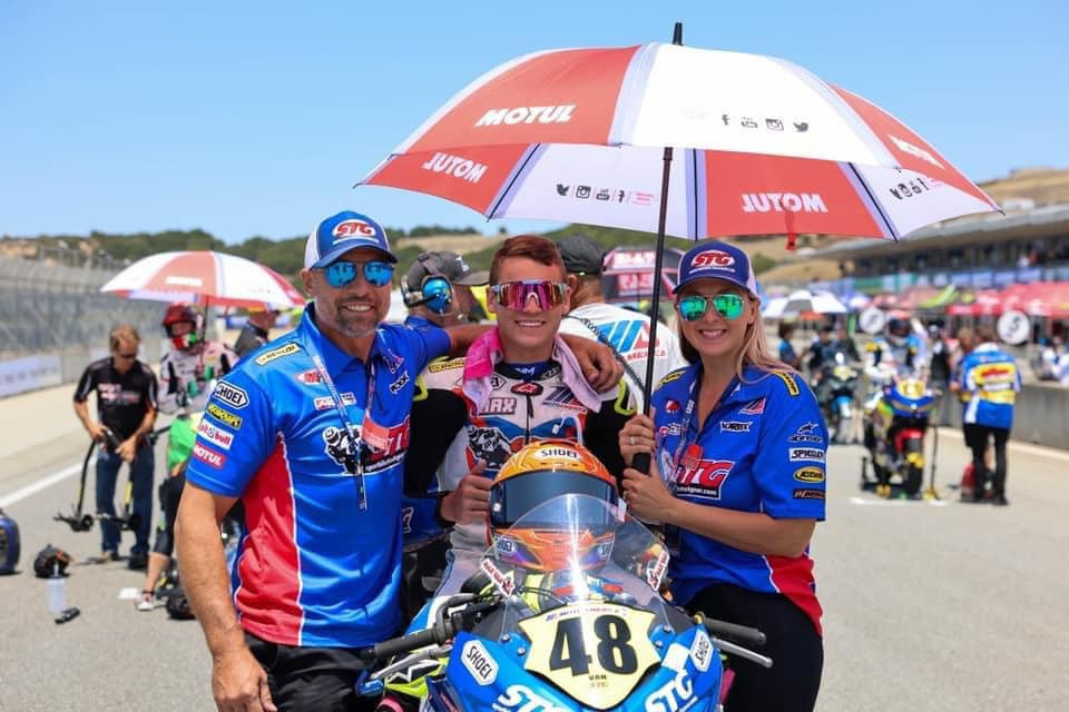 Max Van (center) on the MotoAmerica Junior Cup grid with his father Brian Van (left) and mother Marcine Van (right). Photo courtesy SportbikeTrackGear.com.
