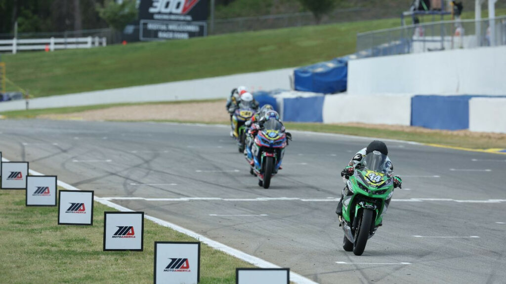 Cody Wyman (34) crosses the finish line with victory in the SportbikeTrackGear.com Junior Cup race on Saturday. Photo by Brian J. Nelson.