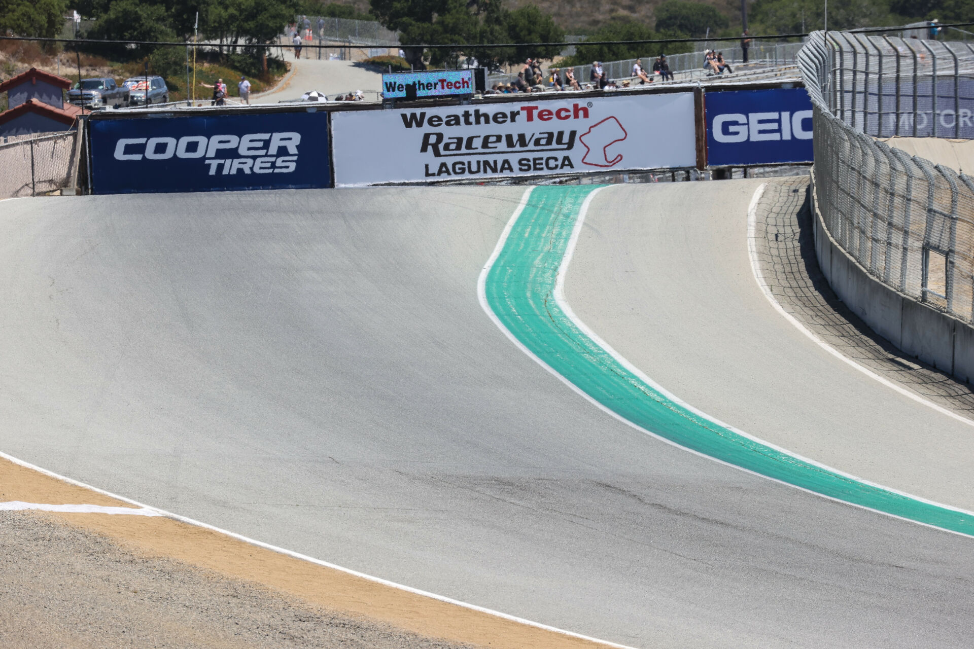 Turn One at Laguna Seca, as seen from Turn Two with the pedestrian bridge set to be replaced visible in the background. Photo by Brian J. Nelson.