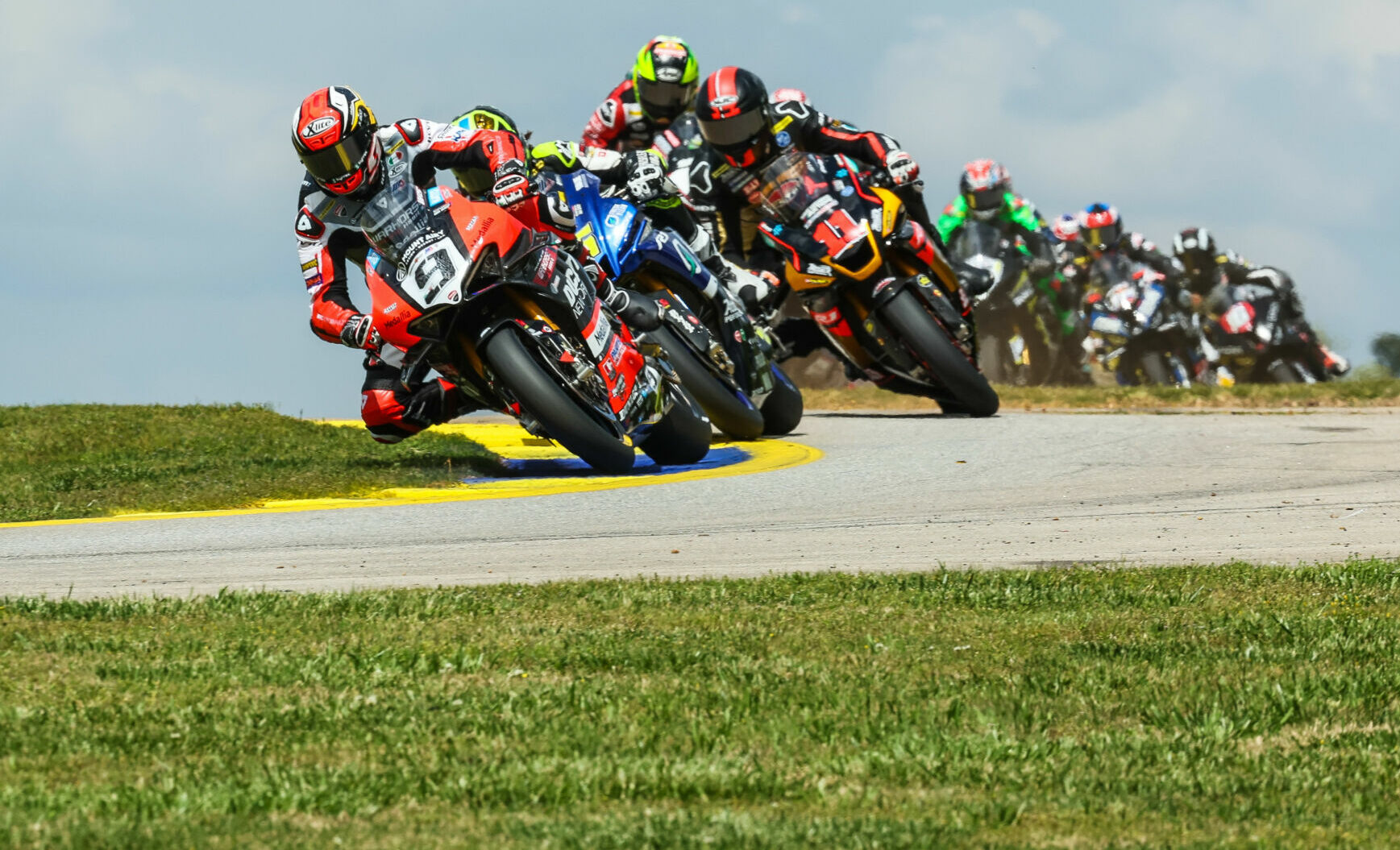 Danilo Petrucci (9) leads a group of riders early in a MotoAmerica Superbike race at Road Atlanta. Photo by Brian J. Nelson, courtesy Ducati.