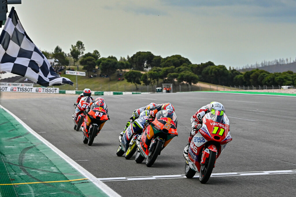 Sergio Garcia (11) leads Jaume Masia (5), Ayumu Sasaki (behind Masia), Deniz Oncu (53), and Izan Guevara (28) across the finish line at the end of the Moto3 race. Photo courtesy Dorna.