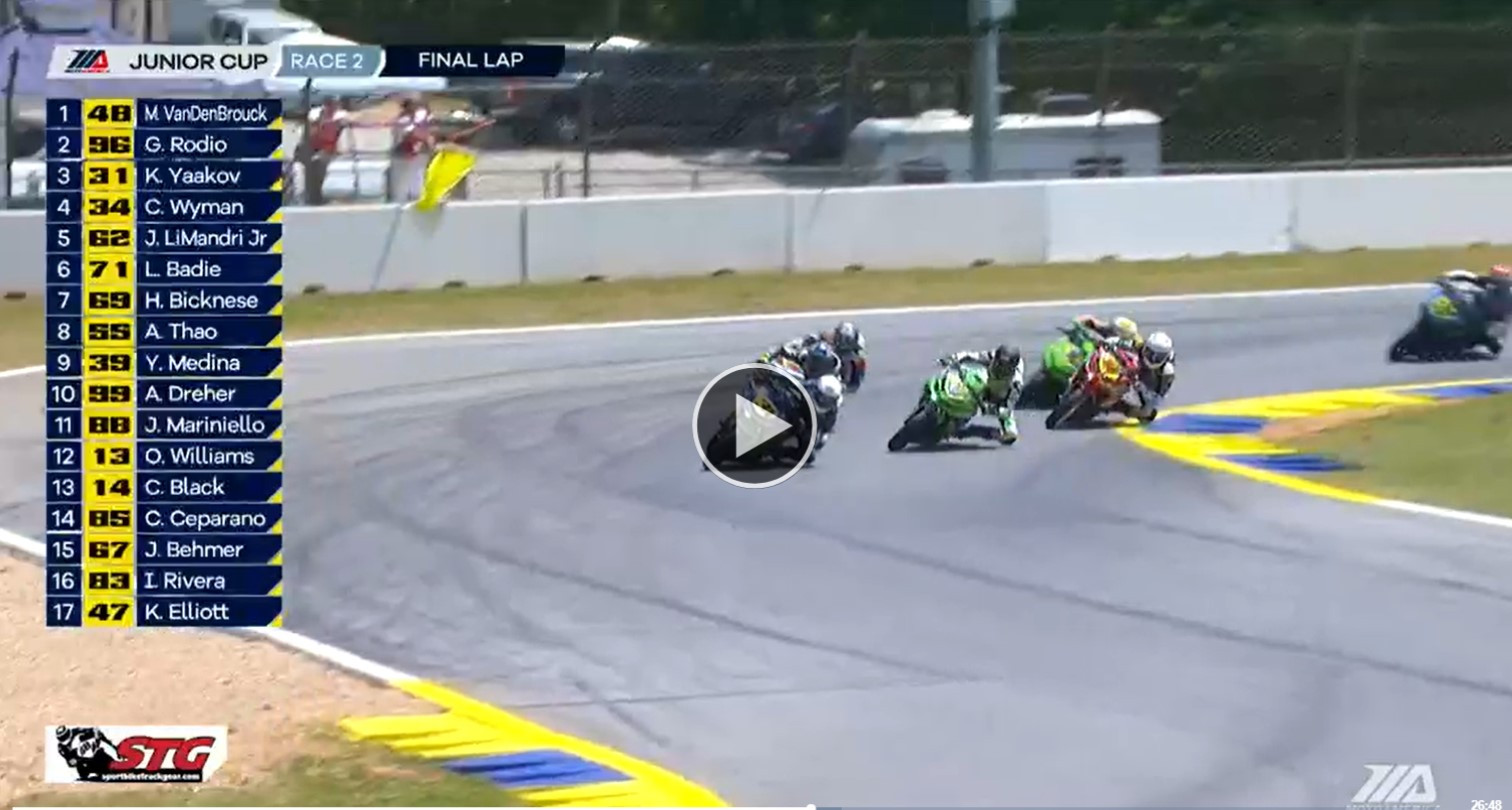 A screen shot from the broadcast of MotoAmerica Junior Cup Race Two showing action in Turn 10 with a stationary yellow flag being displayed in the background. Image courtesy MotoAmerica.