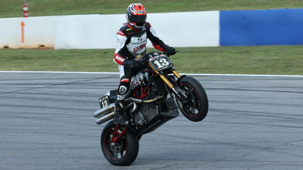 Cory West (13) celebrates with a wheelie after winning the Roland Sands Design Super Hooligan race. Photo by Brian J. Nelson.