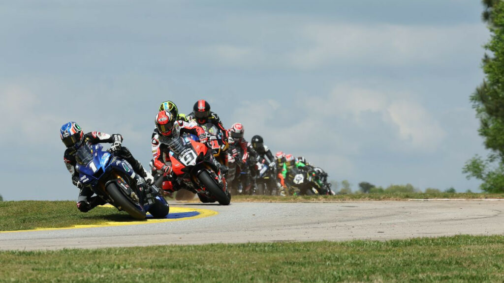 Jake Gagne (1) leads Danilo Petrucci (9) and the rest of the MotoAmerica Medallia Superbike class on the opening lap of Saturday's race at Michelin Raceway Road Atlanta. Photo by Brian J. Nelson.