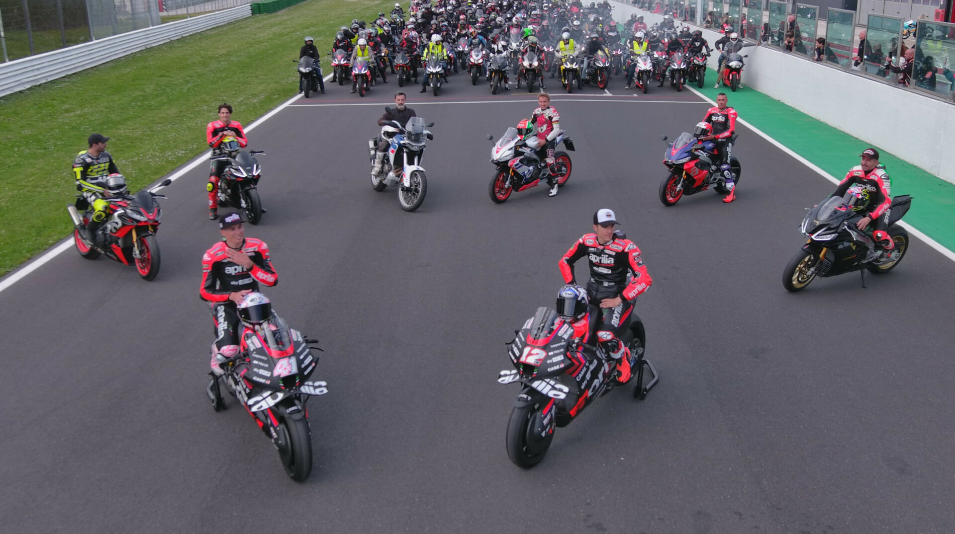 Aprilia stars, present and past, prepare to lead fans on a parade lap at Misano. Photo courtesy Aprilia.