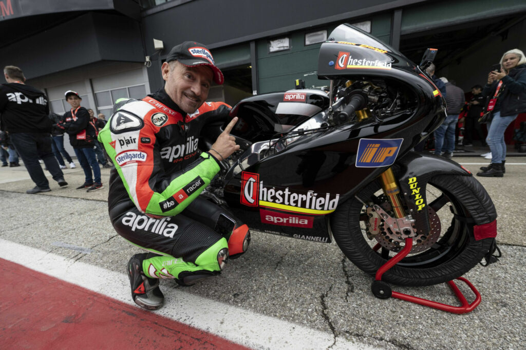 Max Biaggi with his World Championship-winning Aprilia 250cc Grand Prix racebike. Photo courtesy Aprilia.