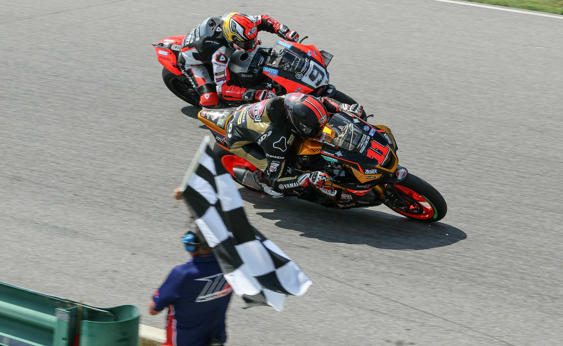 Danilo Petrucci (9) attempting to go around the outside of Mathew Scholtz (11) on the final lap of MotoAmerica Medallia Superbike Race Two at VIR. Petrucci crashed immediately after this photo was taken. Photo by Brian J. Nelson, courtesy Ducati North America.