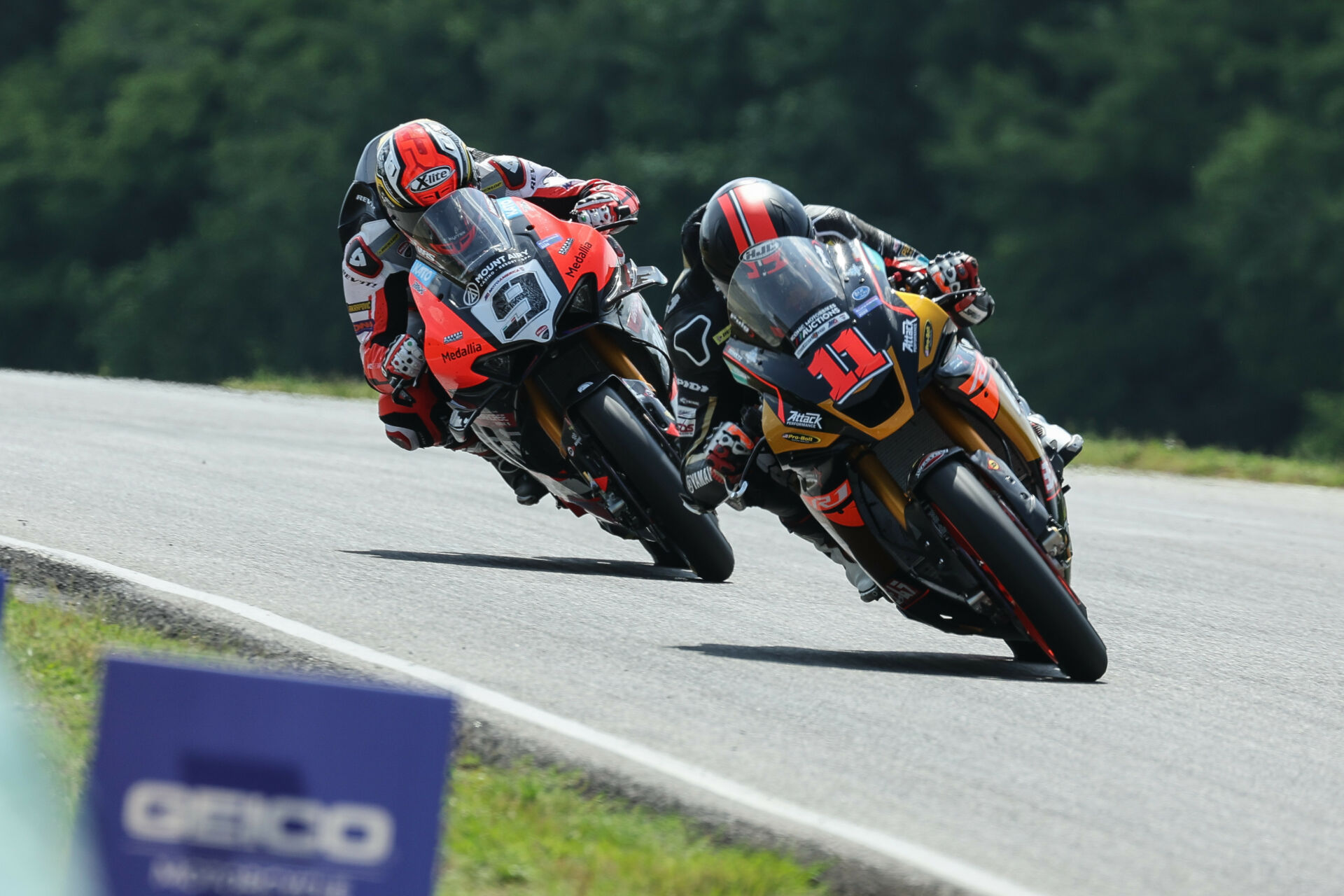 Mathew Scholtz (11) and Danilo Petrucci (9) on the kinked front straightaway at VIRginia International Raceway. Photo by Brian J. Nelson.