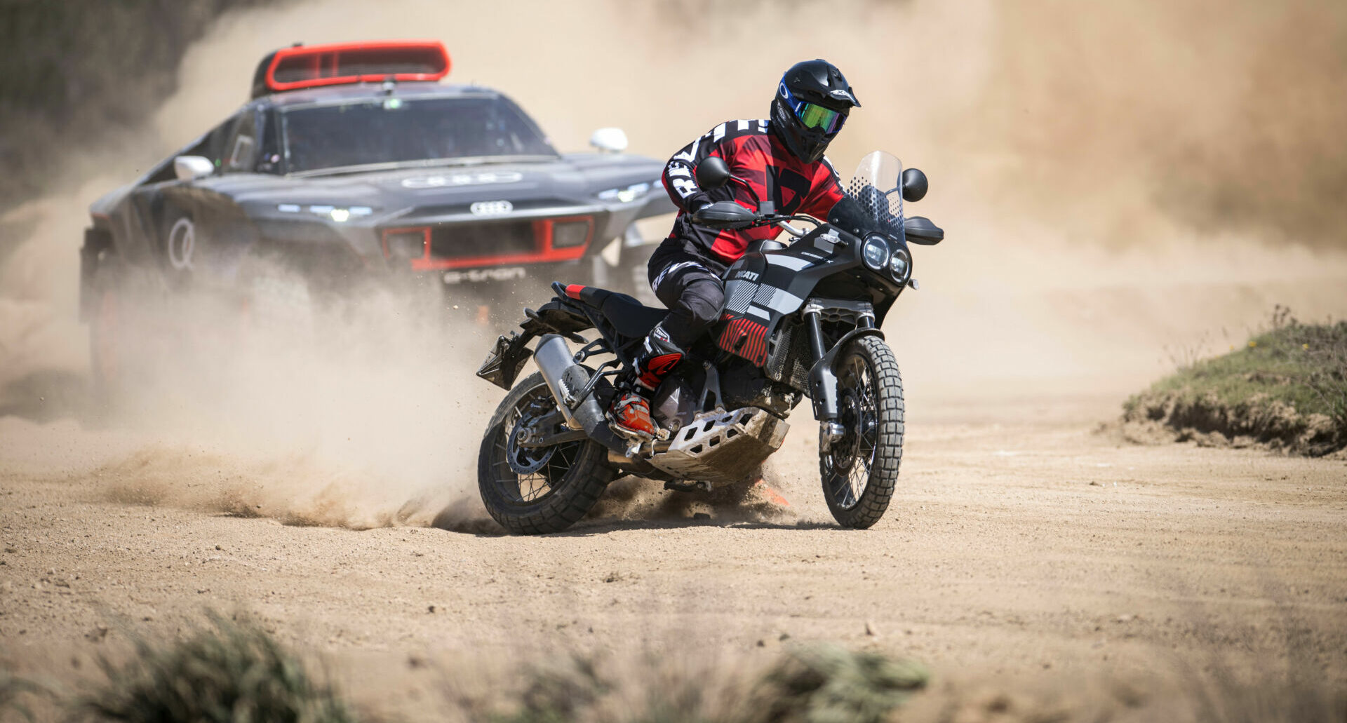 MotoAmerica Superbike racer Danilo Petrucci demonstrates the capabilities of the new Ducati DesertX ahead of an Audi RS Q e-tron prototype rally racer on the Italian island of Sardinia. Photo courtesy Ducati.