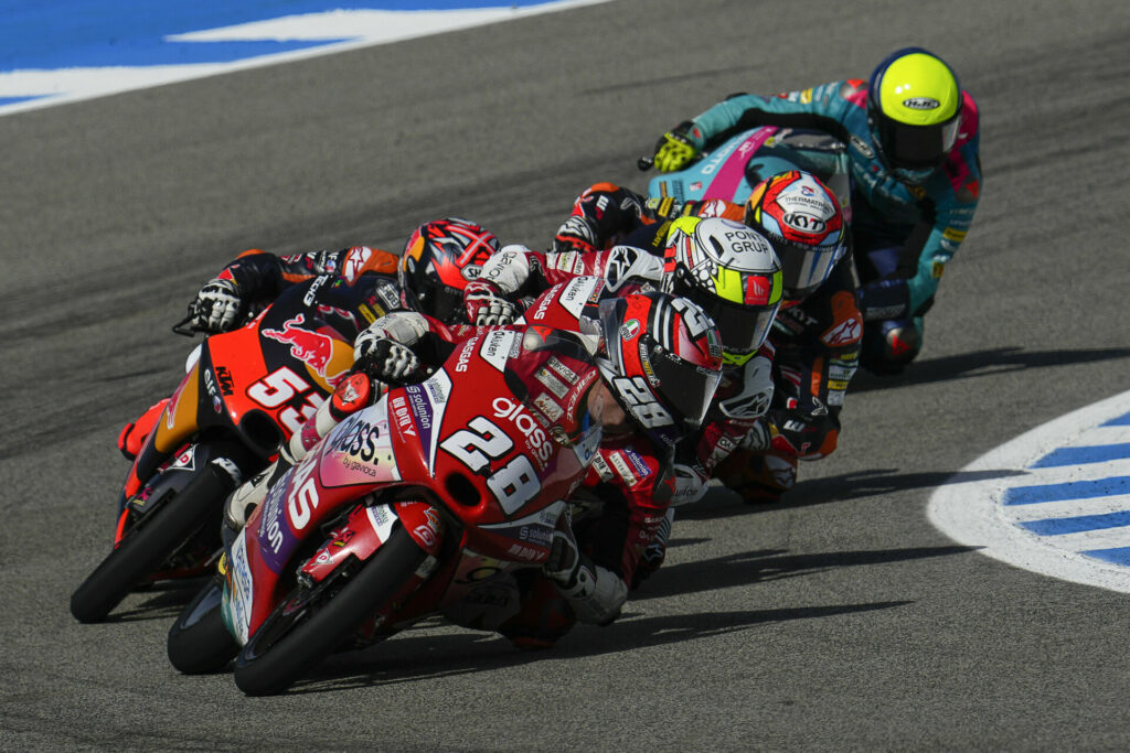 Izan Guevara (28) leads a group of riders during the Moto3 race at Jerez. Photo courtesy Dorna.