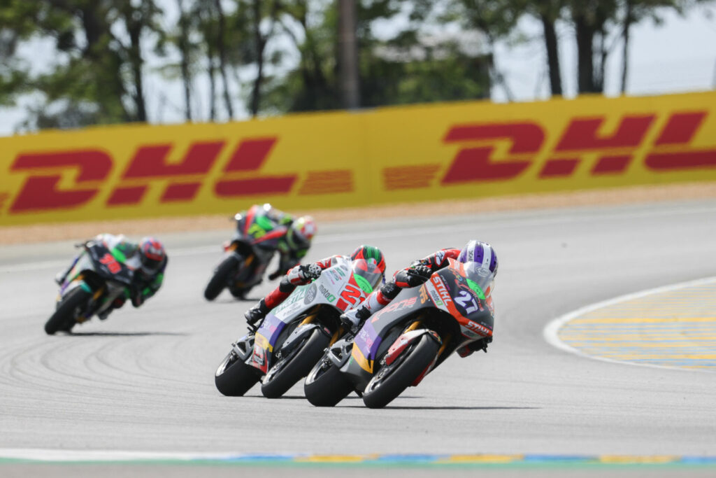 Mattia Casadei (27) leads Kevin Zannoni (21) and others during MotoE Race One. Photo courtesy Dorna.