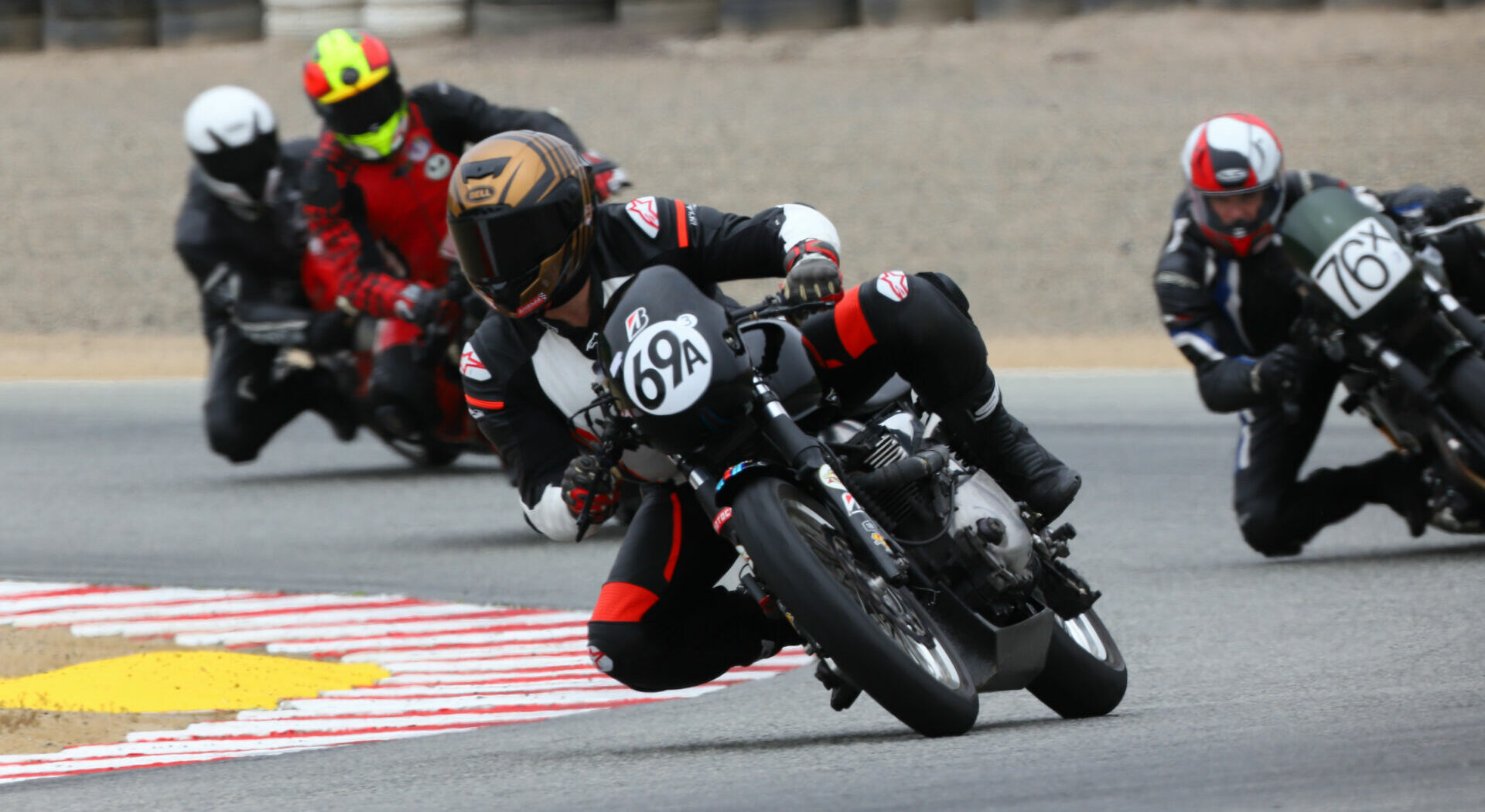 AHRMA Thruxton Cup Challenge racers Carl Estell (69A) and Patrick McGraw (76X) carving Turn Three at Laguna Seca in 2021. Photo by etechphoto.com, courtesy AHRMA.