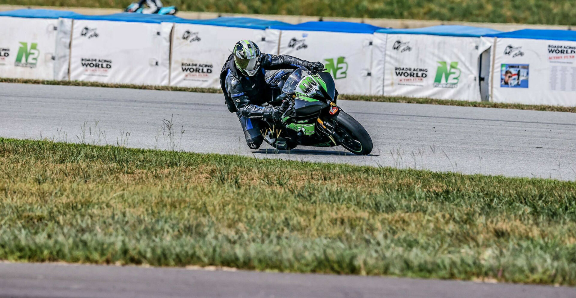 A rider at speed in front of Airfence Bike soft barriers purchased with funds from a previous N2 Track Days fundraiser for the Roadracing World Action Fund. Photo by Apex Pro Photo, courtesy N2 Track Days.