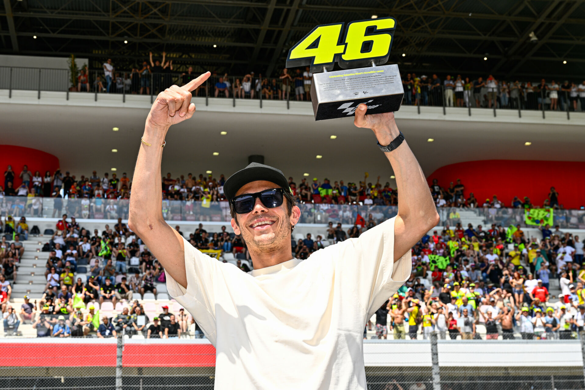 Valentino Rossi with a trophy symbolizing the retirement of his number 46 from use in MotoGP competition. Photo courtesy Dorna.