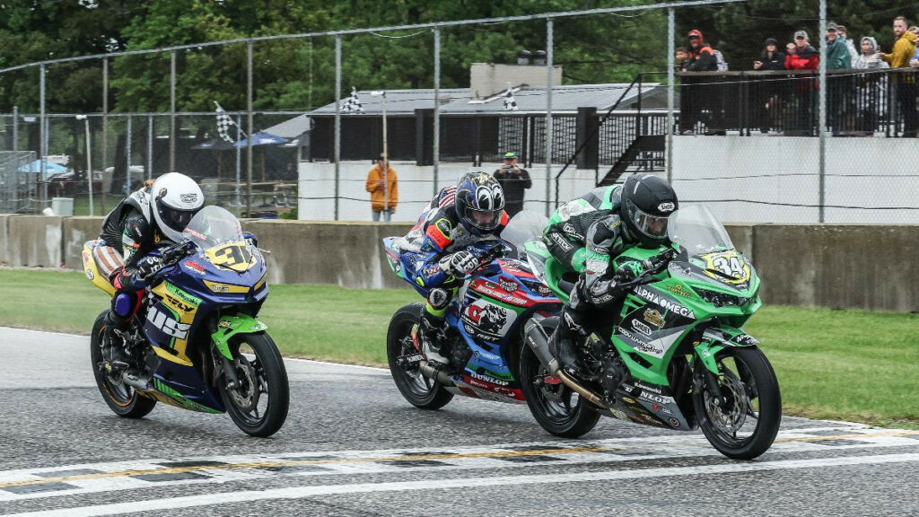 Cody Wyman (34) beats Joe Milandri Jr. (62) and Kayla Yaakov (31) to the finish line in the SportbikeTrackGear.com Junior Cup race on Sunday. Photo by Brian J. Nelson, courtesy MotoAmerica.