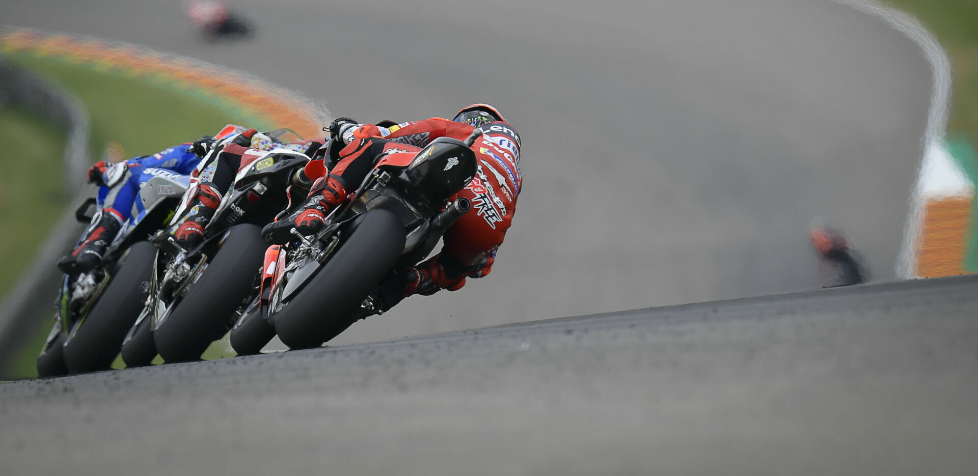 Alex Rins leads Takaaki Nakagami and Francesco Bagnaia at Sachsenring in 2021. Photo courtesy Dorna.