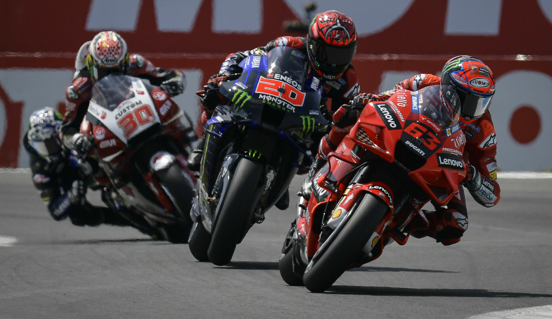 Francesco Bagnaia (63) leads Fabio Quartararo (20), Takaaki Nakagami (30), and Maverick Vinales early in the MotoGP race at Assen in 2021. Photo courtesy Dorna.