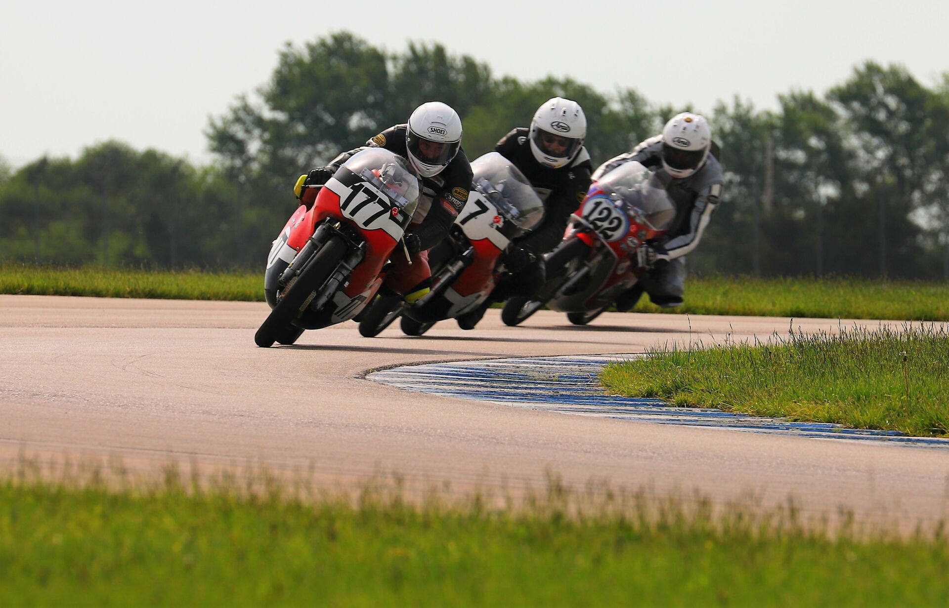 Walt Fulton (177), Dave Roper (7), and Alex McLean (122) racing closely during the 350 GP at Heartland Motorsports Park. Photo by etechphoto.com, courtesy AHRMA.