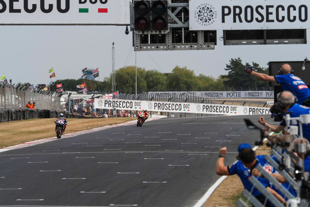 Toprak Razgatlioglu (1) leads Alvaro Bautista (19) to the checkered flag at the end of Race Two at Donington Park. Photo courtesy Dorna WorldSBK Press Office.