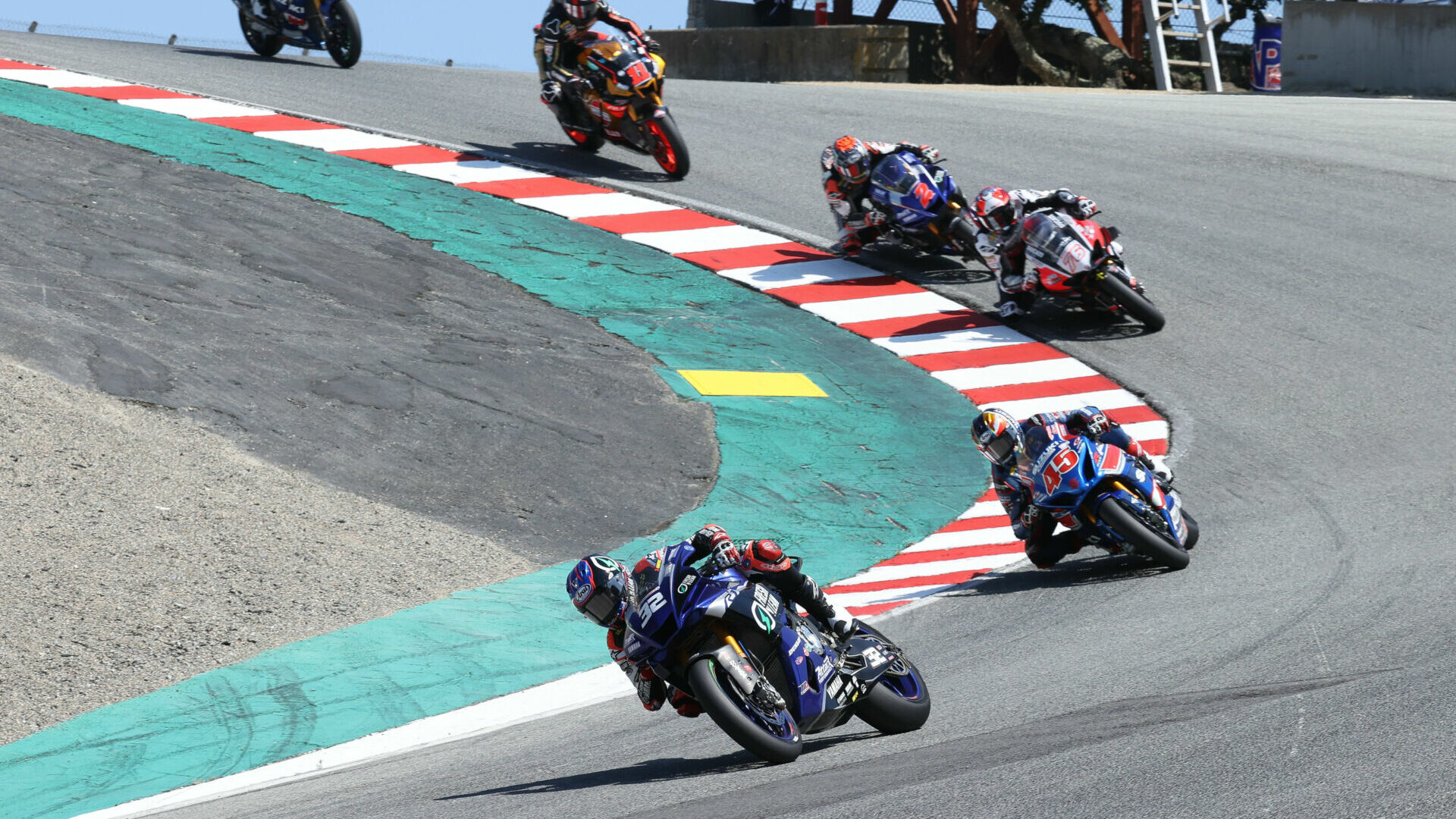 Jake Gagne (32) leads Cameron Petersen (45), Loris Baz (76), Josh Herrin (2), and Mathew Scholtz (11) down the Corkscrew at Laguna Seca in 2021. Photo by Brian J. Nelson.